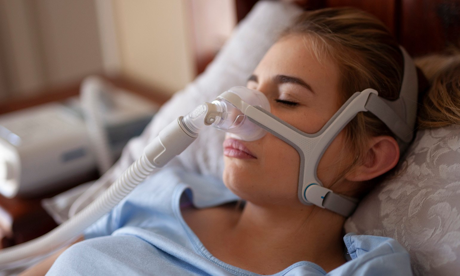 young-woman-in-bed-cpap-machine