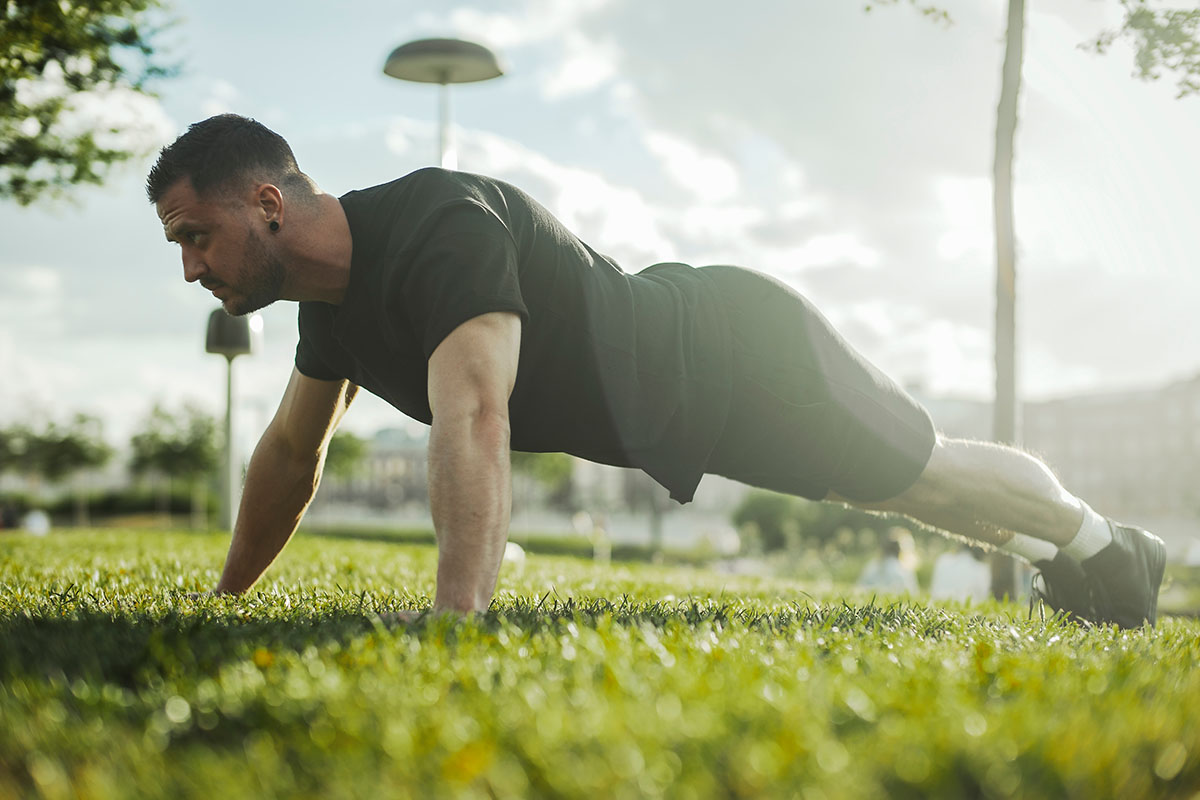 Close,Up,Of,Young,Attractive,Man,Exercising,Plank,Outdoors.,Side